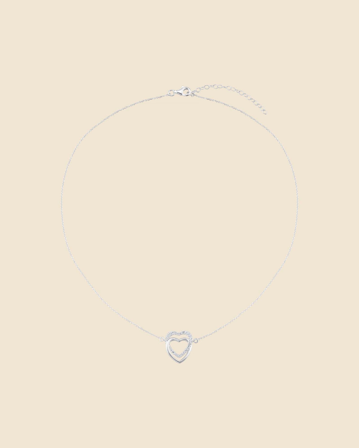 Sterling silver necklace with two interlinked hearts, one polished and one accented with sparkling cubic zirconia.
