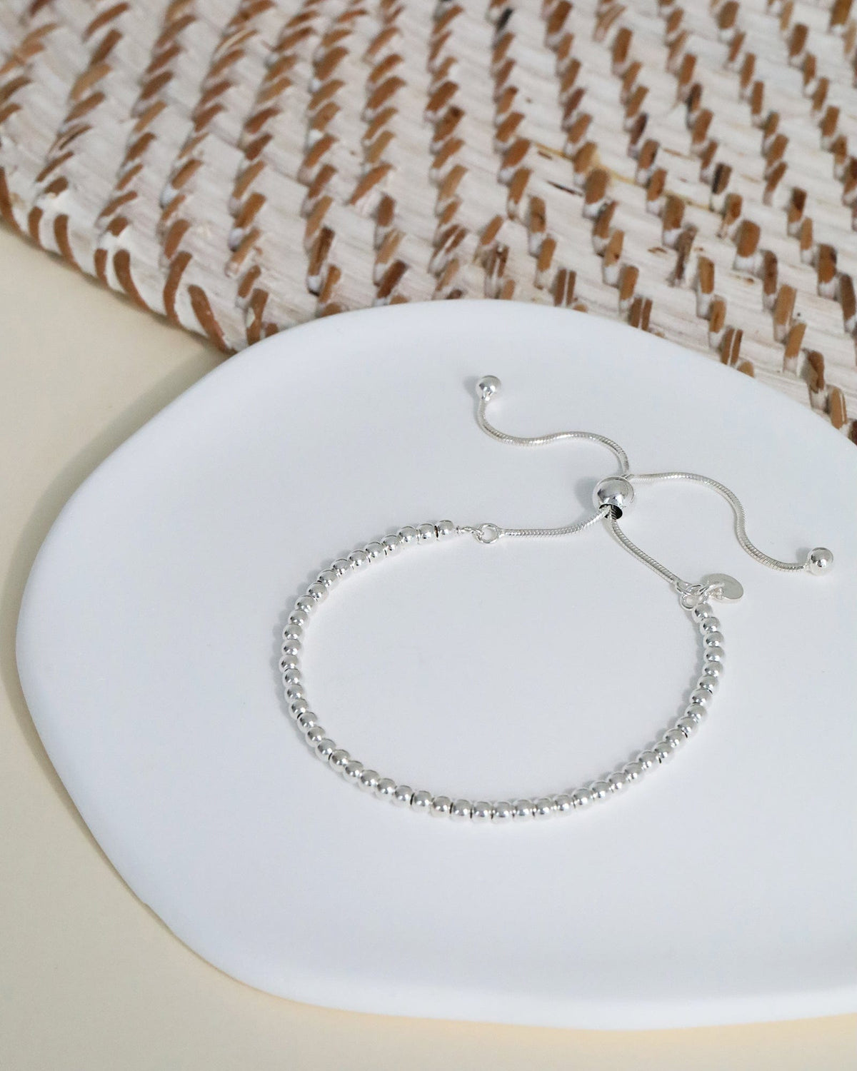 Sterling silver beaded slider bracelet with an adjustable chain, faceted slider ball, and hallmark tag on a white display.