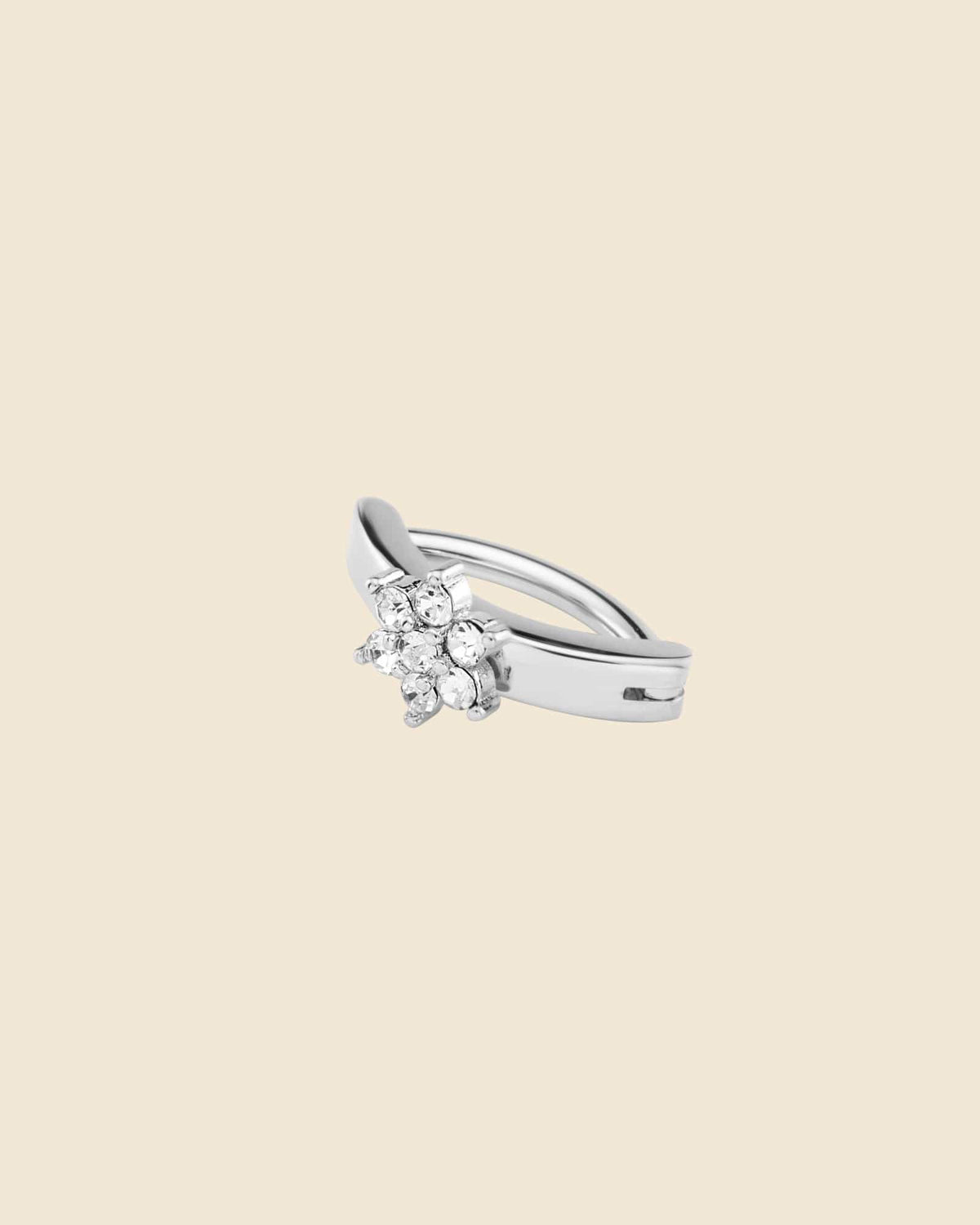 Silver surgical steel curved clicker navel ring featuring a sparkling cubic zirconia flower charm.