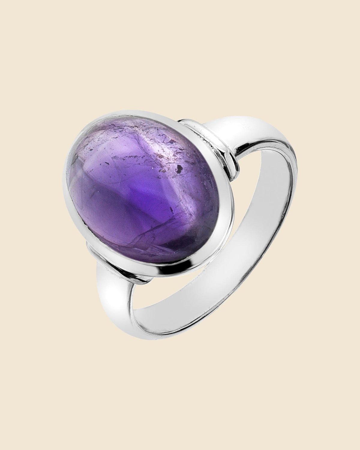 Sterling silver ring featuring a polished oval amethyst dome gemstone in a classic bezel setting.