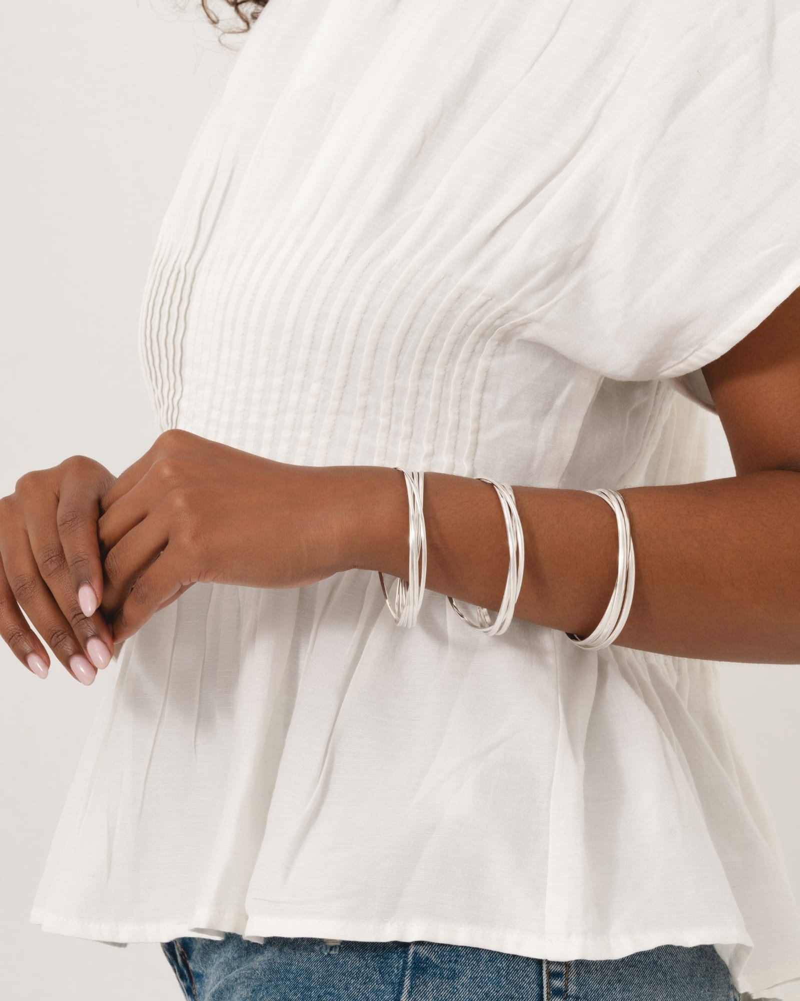 Sterling silver Russian wedding style bangle featuring five interlinked slim bands worn on a model's wrist.