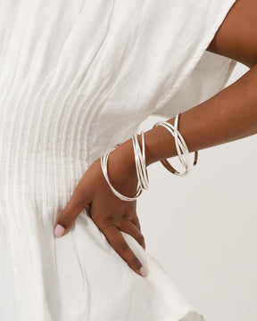 Five interlinked sterling silver bands in a Russian wedding style bangle worn on a wrist.
