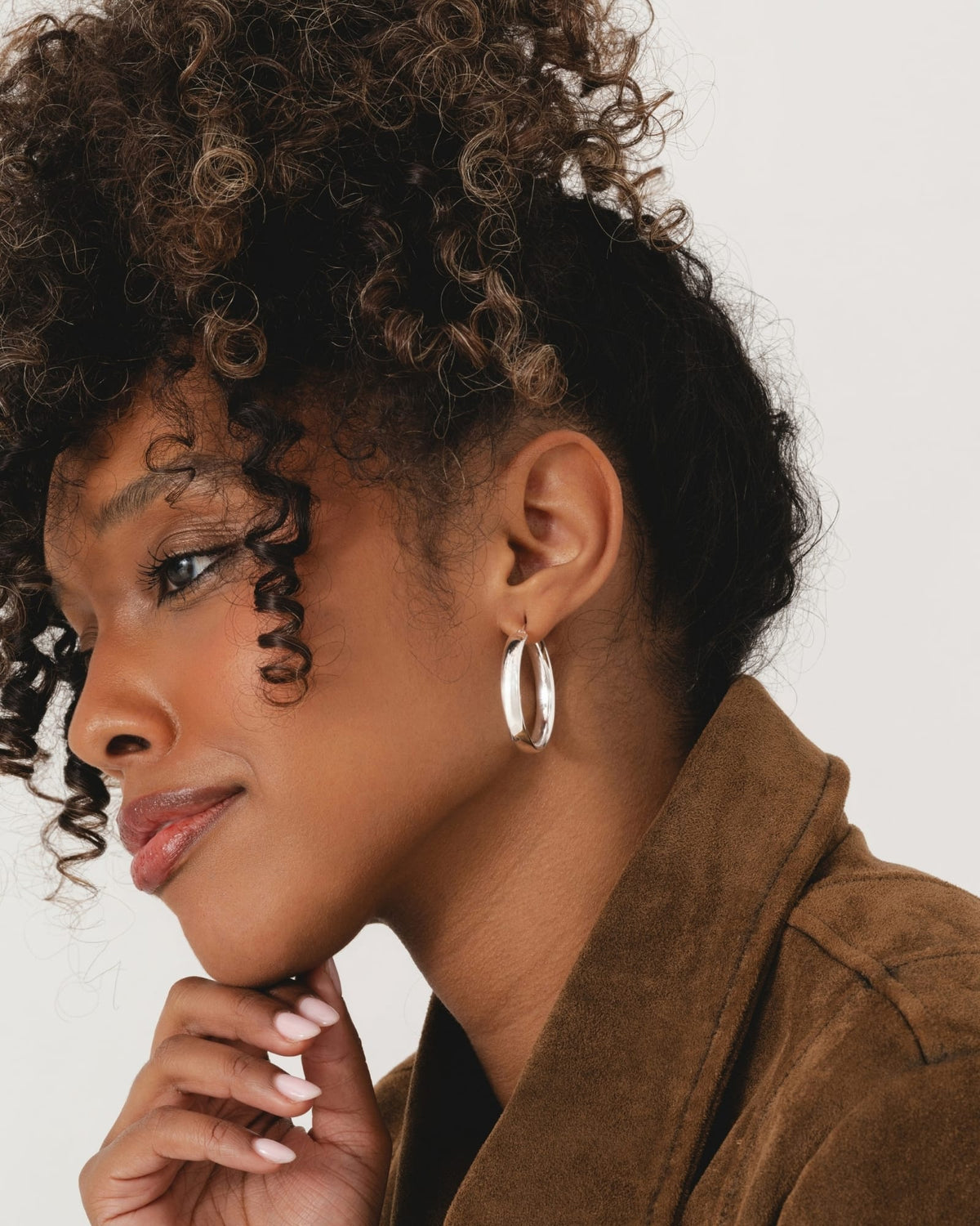 Model wearing polished 35mm sterling silver wide flip-top hoop earrings.