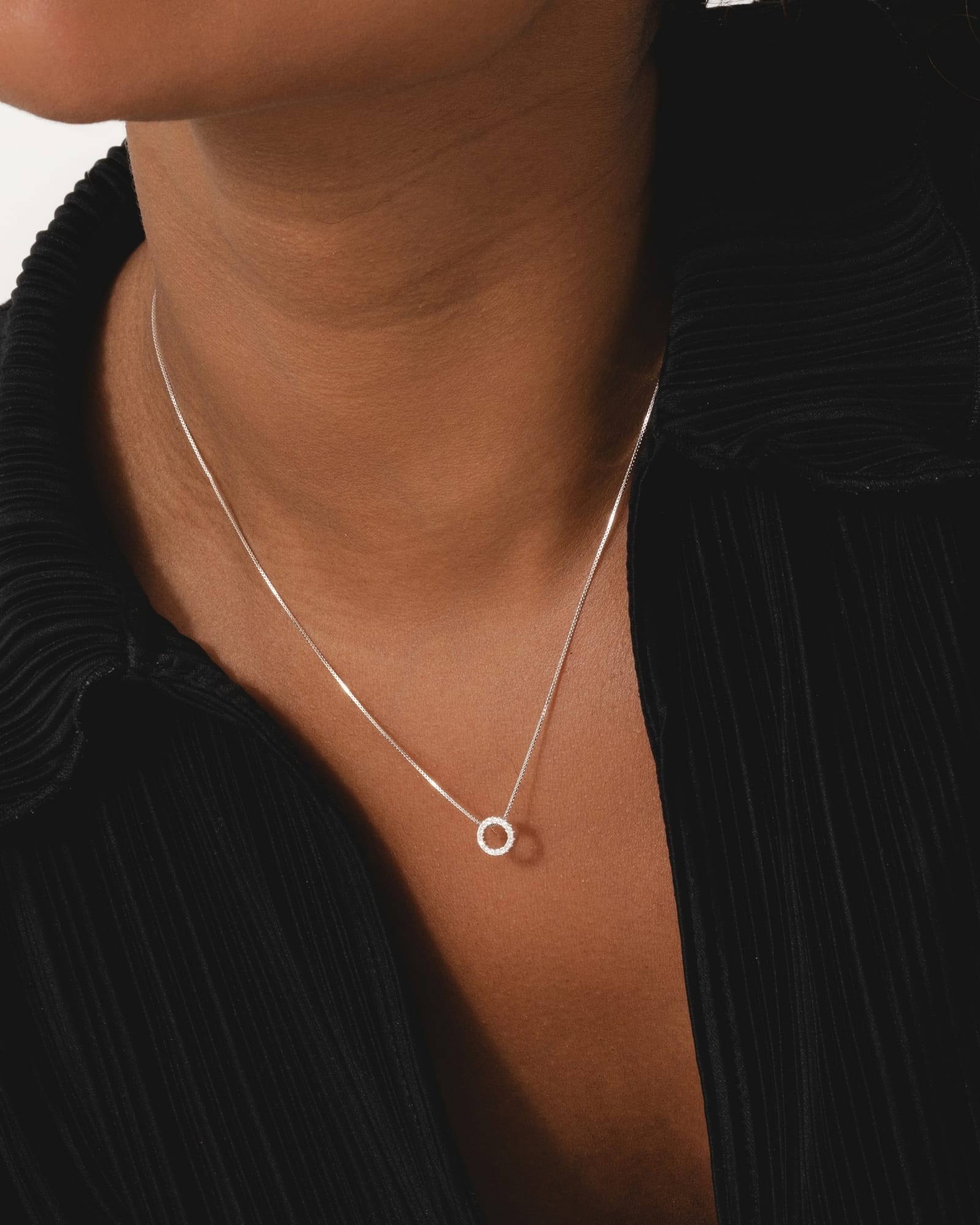 Sterling silver mini circle pendant necklace with sparkling cubic zirconia on a delicate silver chain.
