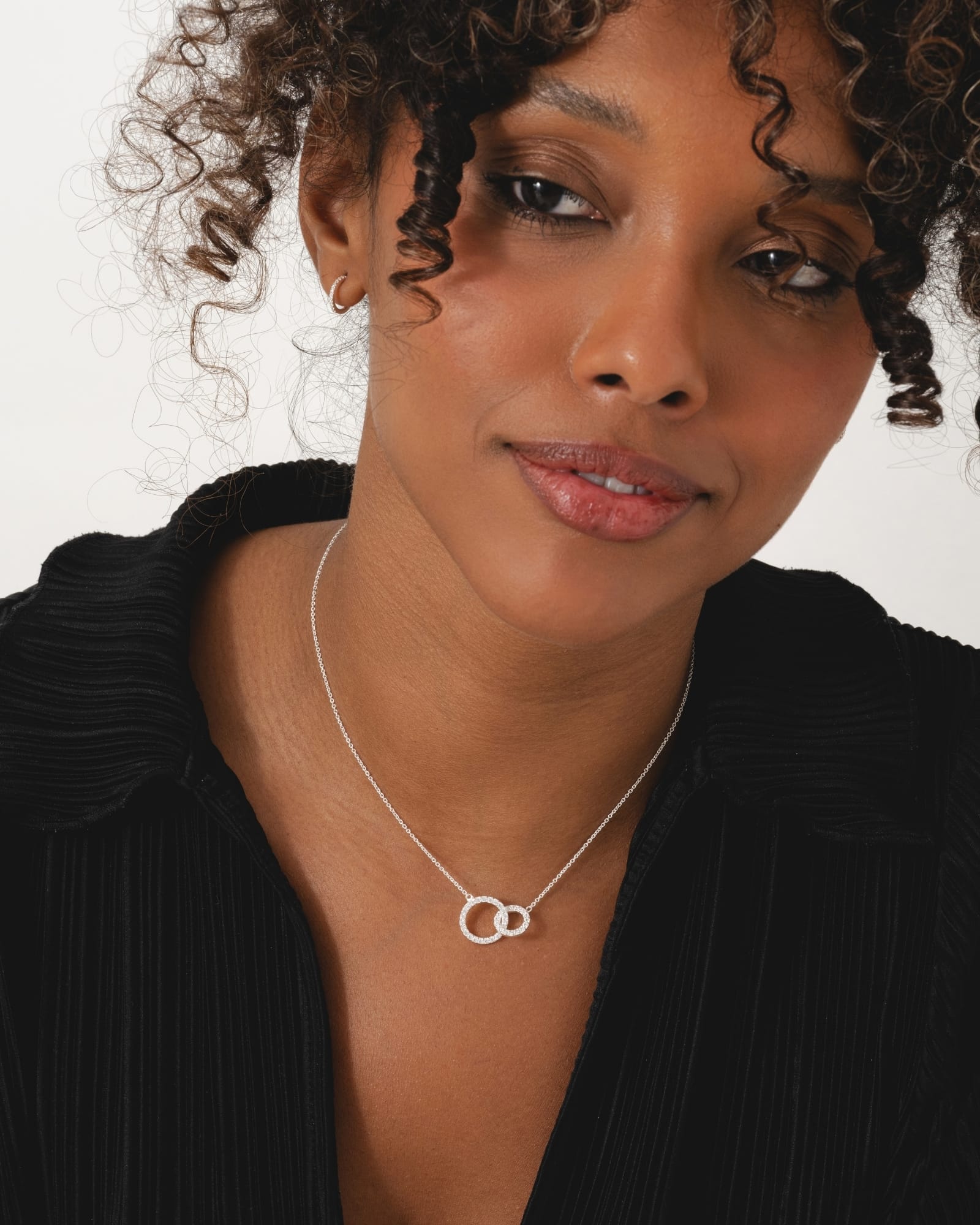 Sterling silver interlinked circles necklace featuring sparkling cubic zirconia stones on a delicate chain.