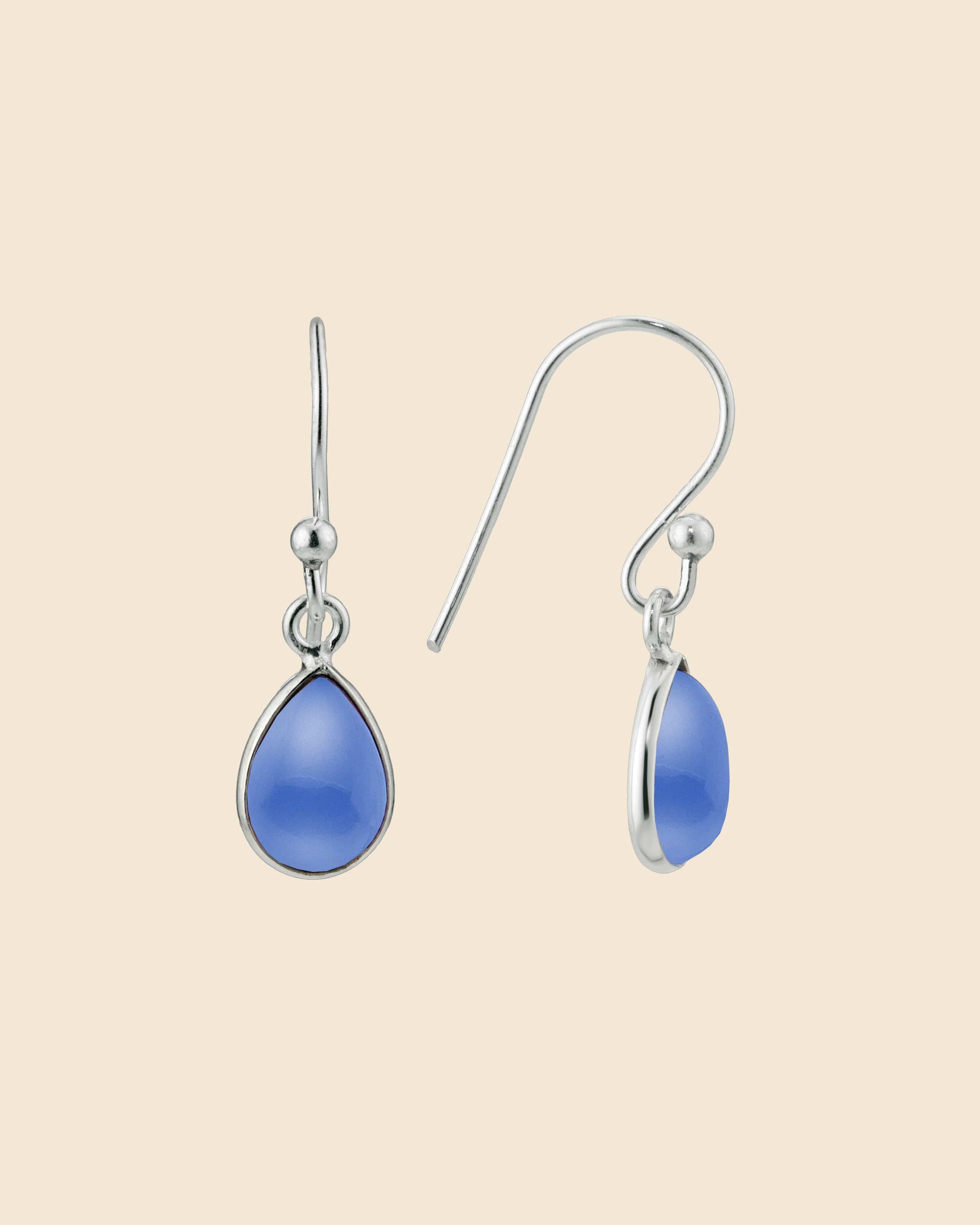 Sterling silver teardrop earrings featuring smooth, pale blue chalcedony gemstones on simple hook wires.