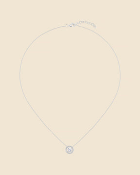 Sterling silver necklace with a circular cubic zirconia halo pendant on a delicate fine chain.