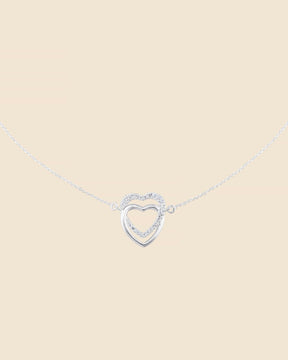 Sterling silver necklace with two interlinked hearts, one polished silver and one accented with sparkling cubic zirconia.