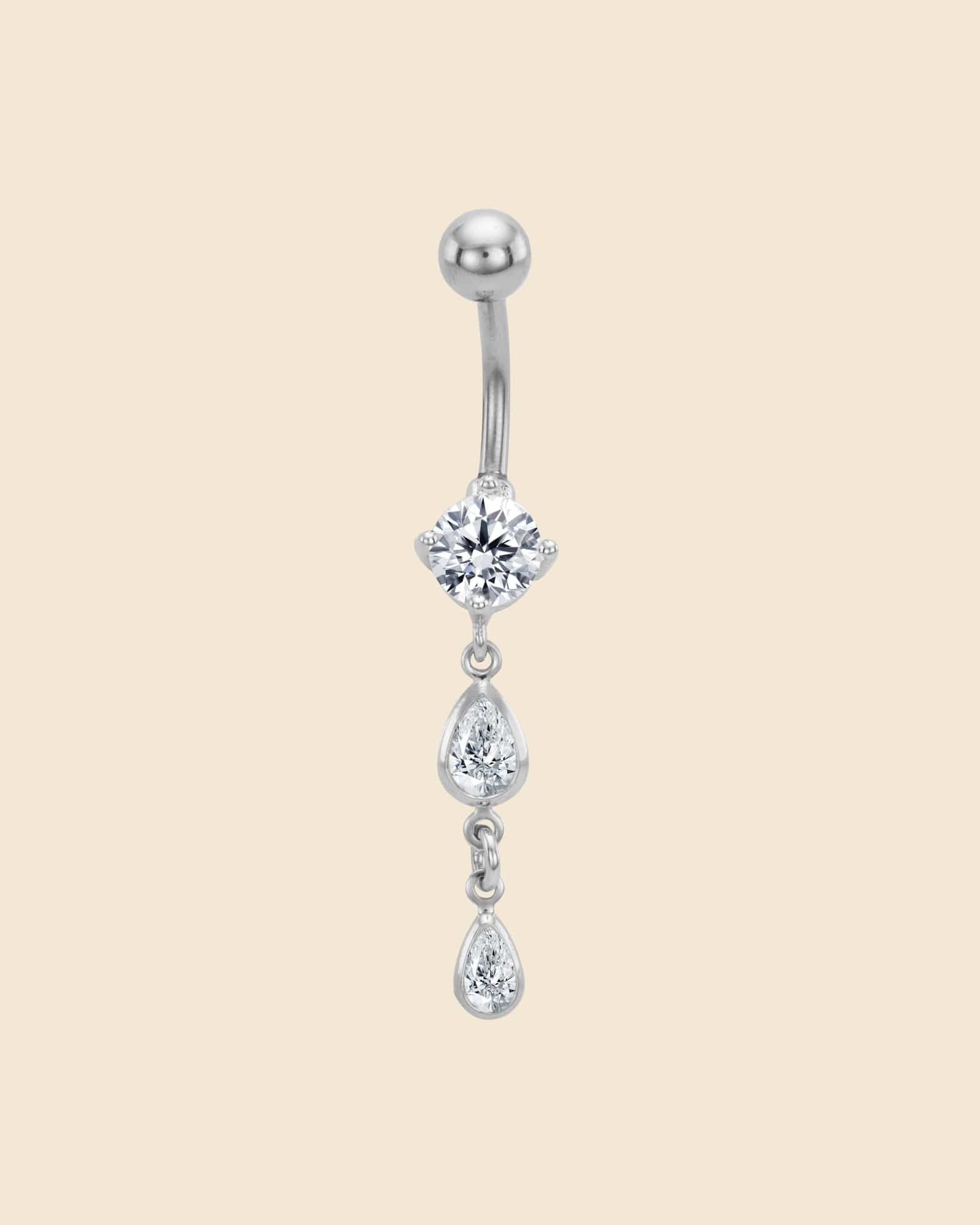 Surgical steel navel bar with a claw-set crystal and two dangling teardrop-shaped crystals.
