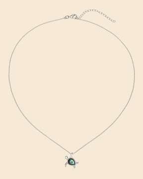 Sterling silver turtle pendant necklace featuring a vibrant, iridescent paua shell inlay on a delicate chain.