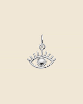Dainty sterling silver evil eye pendant with a polished center bead and stylized eyelash detailing.